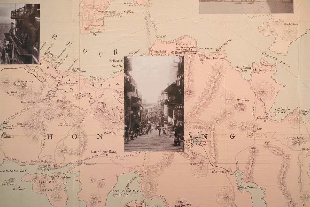 A historical map of Hong Kong Island with an archival photograph of a stepped street laid over it.