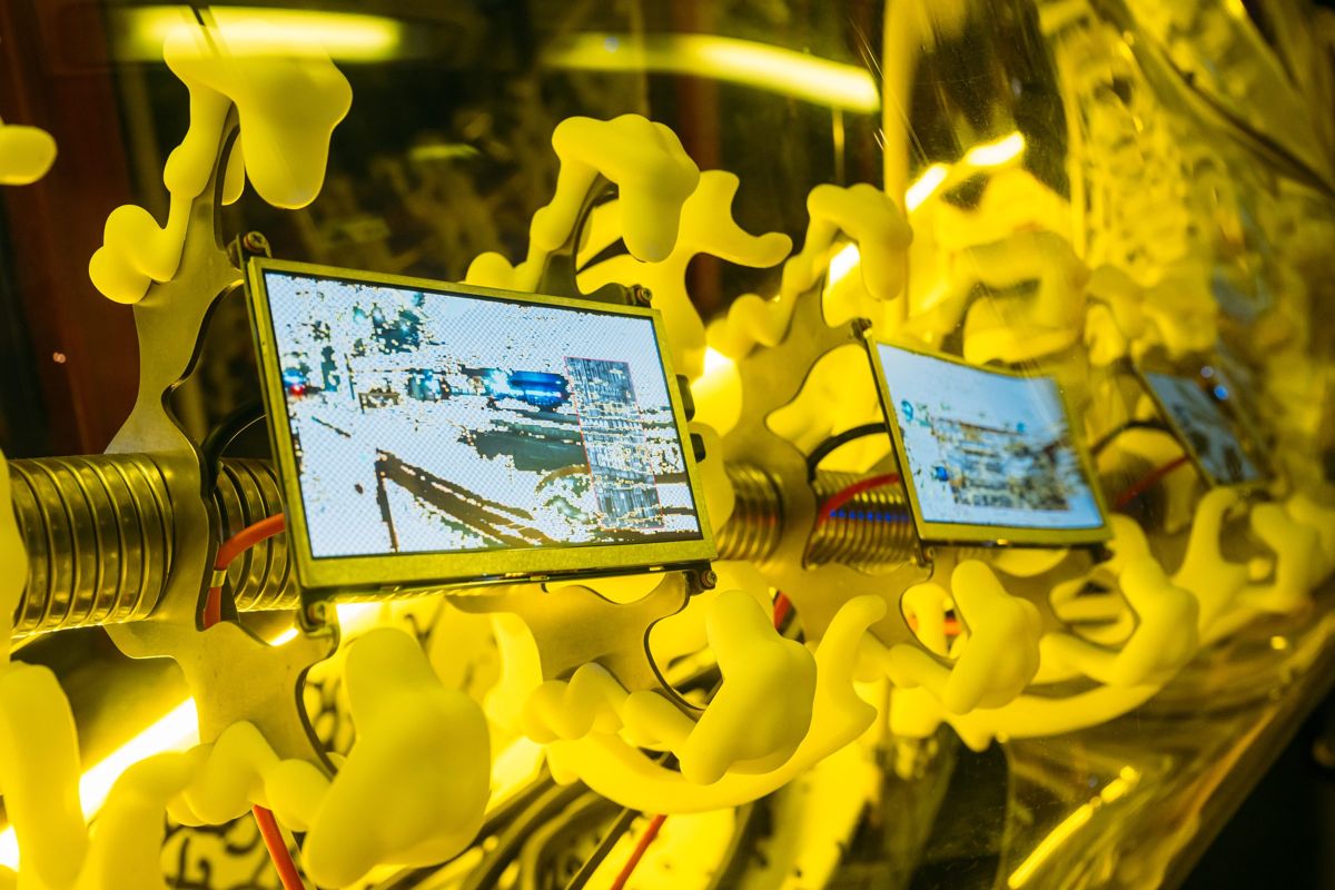 Close-up of small screens embedded in yellow organic forms.