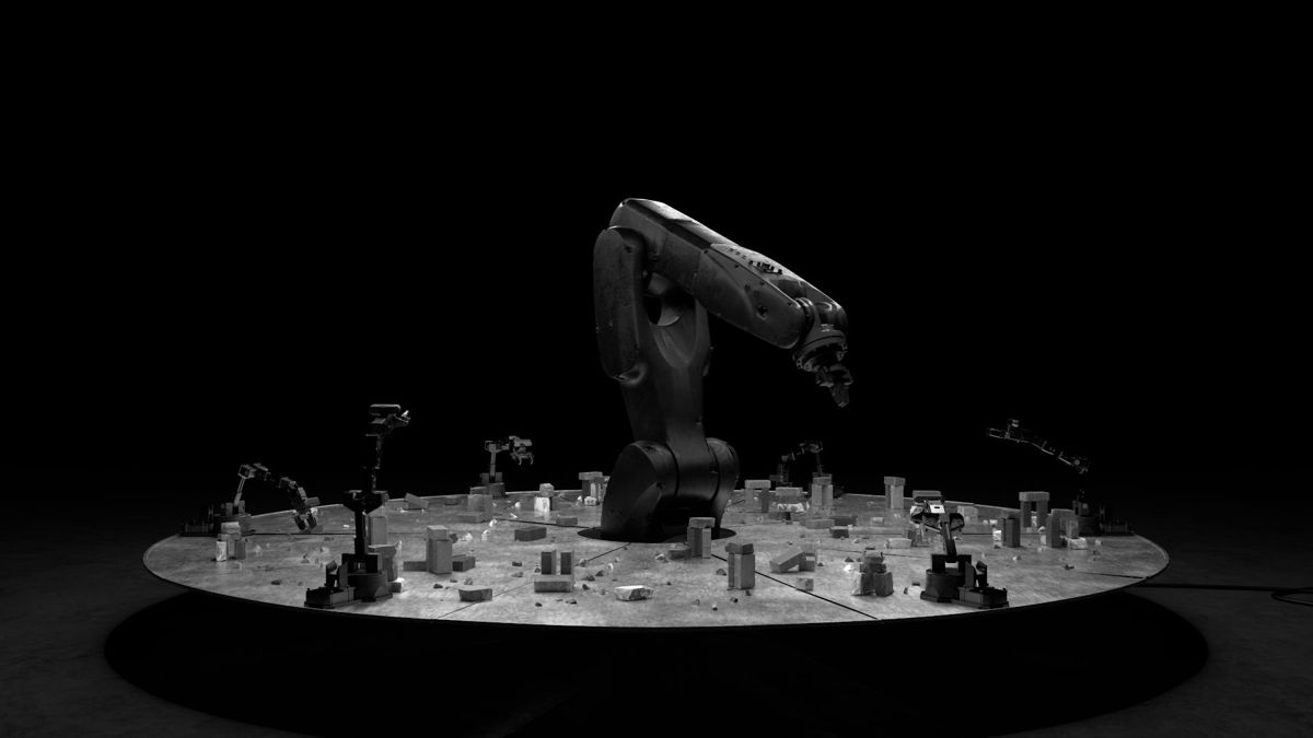 The circular table seen from a distance, the industrial arm at its centre and small arms around the edge.