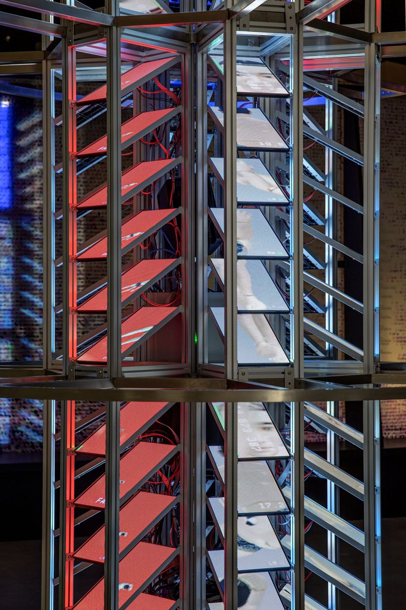 Racks of angled screens, red on one side and white on the other.