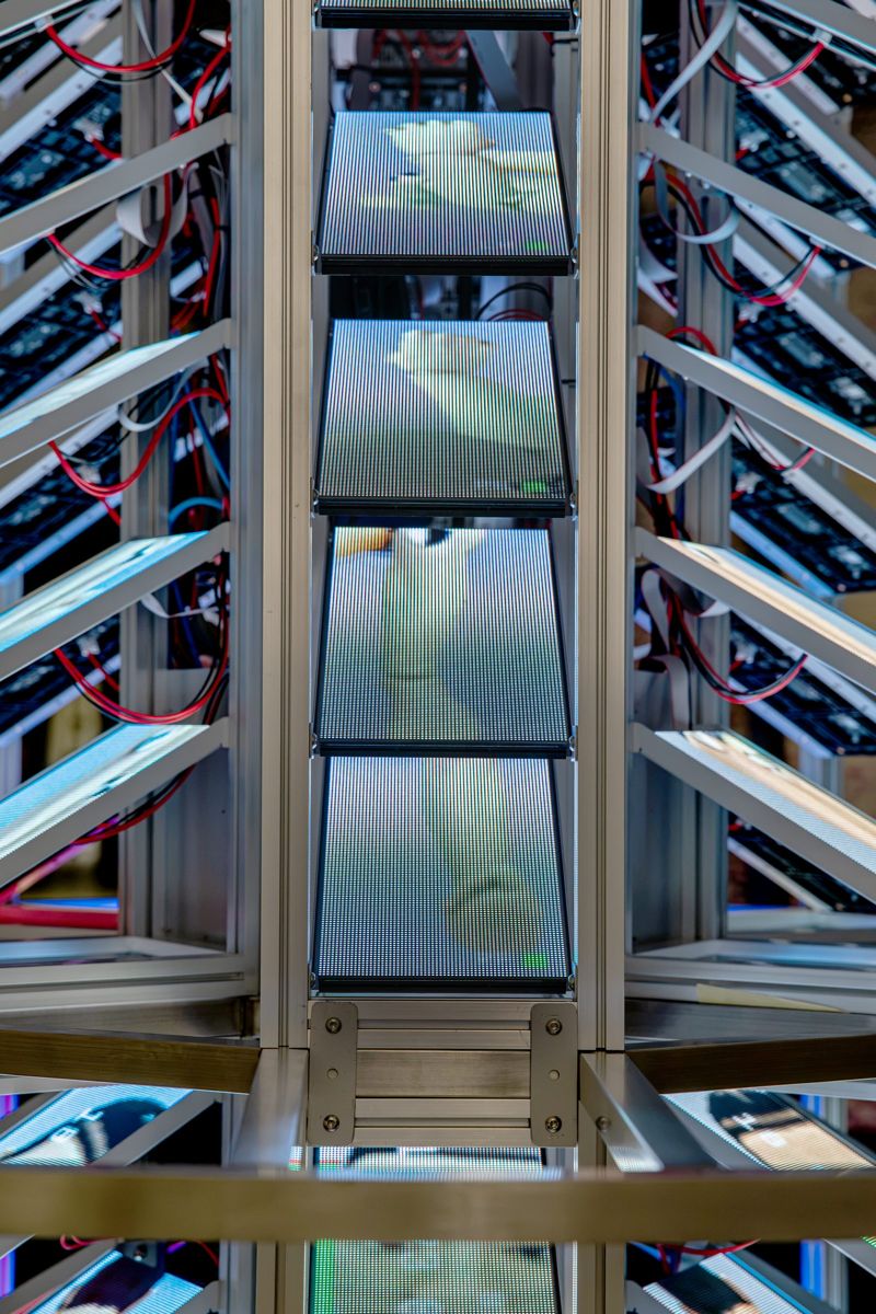 Looking up a column of screens, each showing a climbing figure.