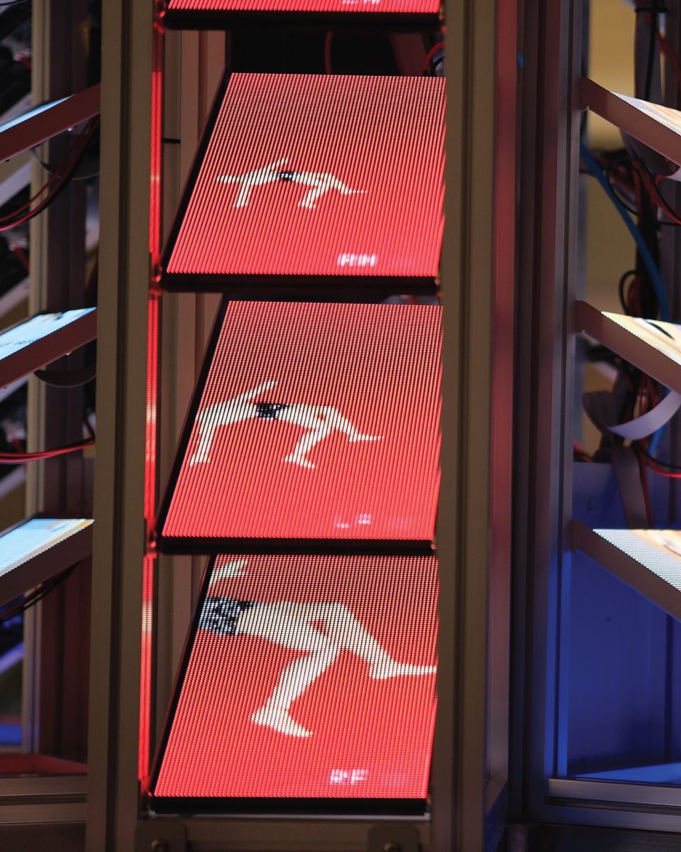 Red screens stacked in the frame, each showing a figure mid-climb.
